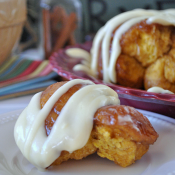 Pumpkin Monkey Bread | Yummy pumpkin bread coated in a caramel like sauce and drizzled with a cream cheese frosting. Does fall really get any better than this?? #pumpkin #recipes #bread