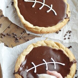 Be the hero of your tailgating parties this weekend! Bake my Quick & Easy Chocolate Chip Cookie recipe into 2 round cake pans, make a quick cut in the middle plus frosting, and voila! A football cookie cake in no time.