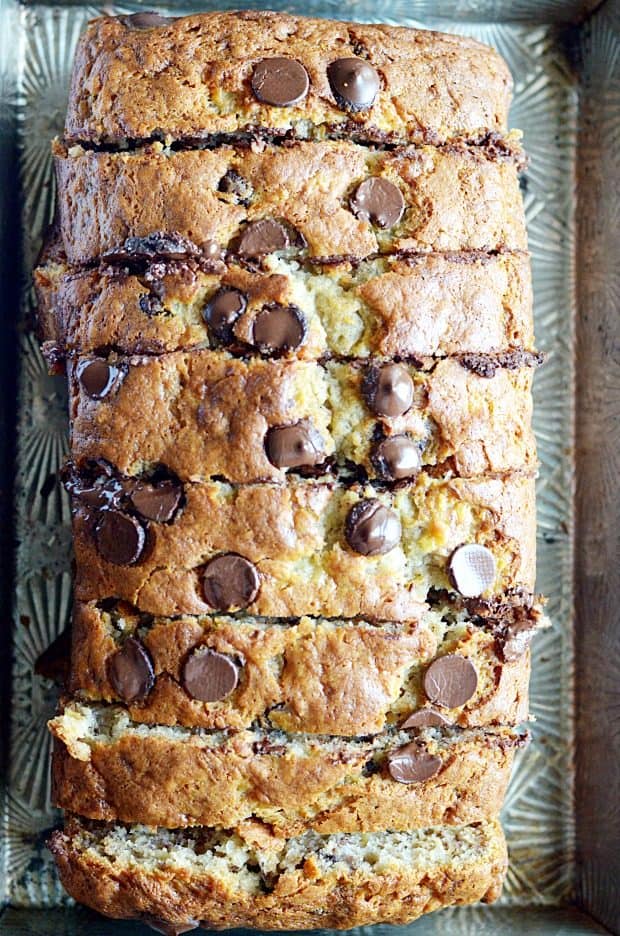 My mom's banana bread is full of chocolate chips and is SUPER soft and moist thanks to 4 whole bananas and a little bit of oil. It's the best!