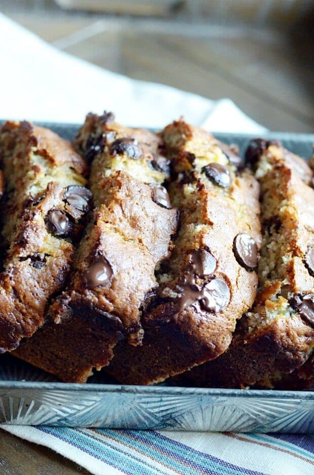 My mom's banana bread is full of chocolate chips and is SUPER soft and moist thanks to 4 whole bananas and a little bit of oil. It's the best!