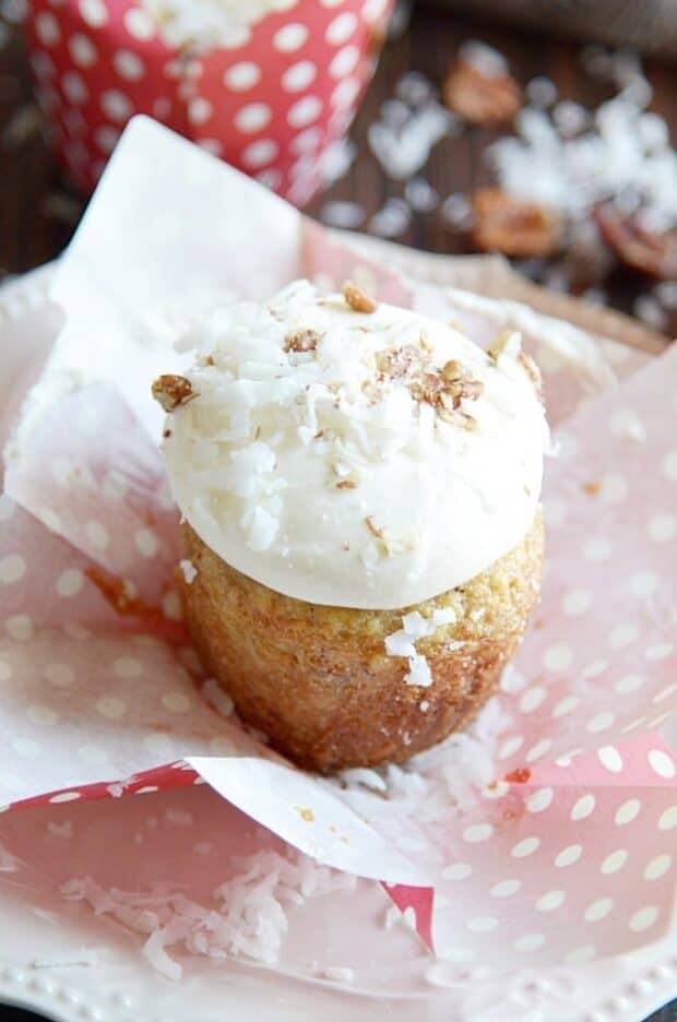 This Southern classic is banana bread and cupcake all rolled into one! A super moist banana cupcake with crushed pineapple, coconut, and pecans folded into the batter topped with an irresistibly dreamy cream cheese frosting.