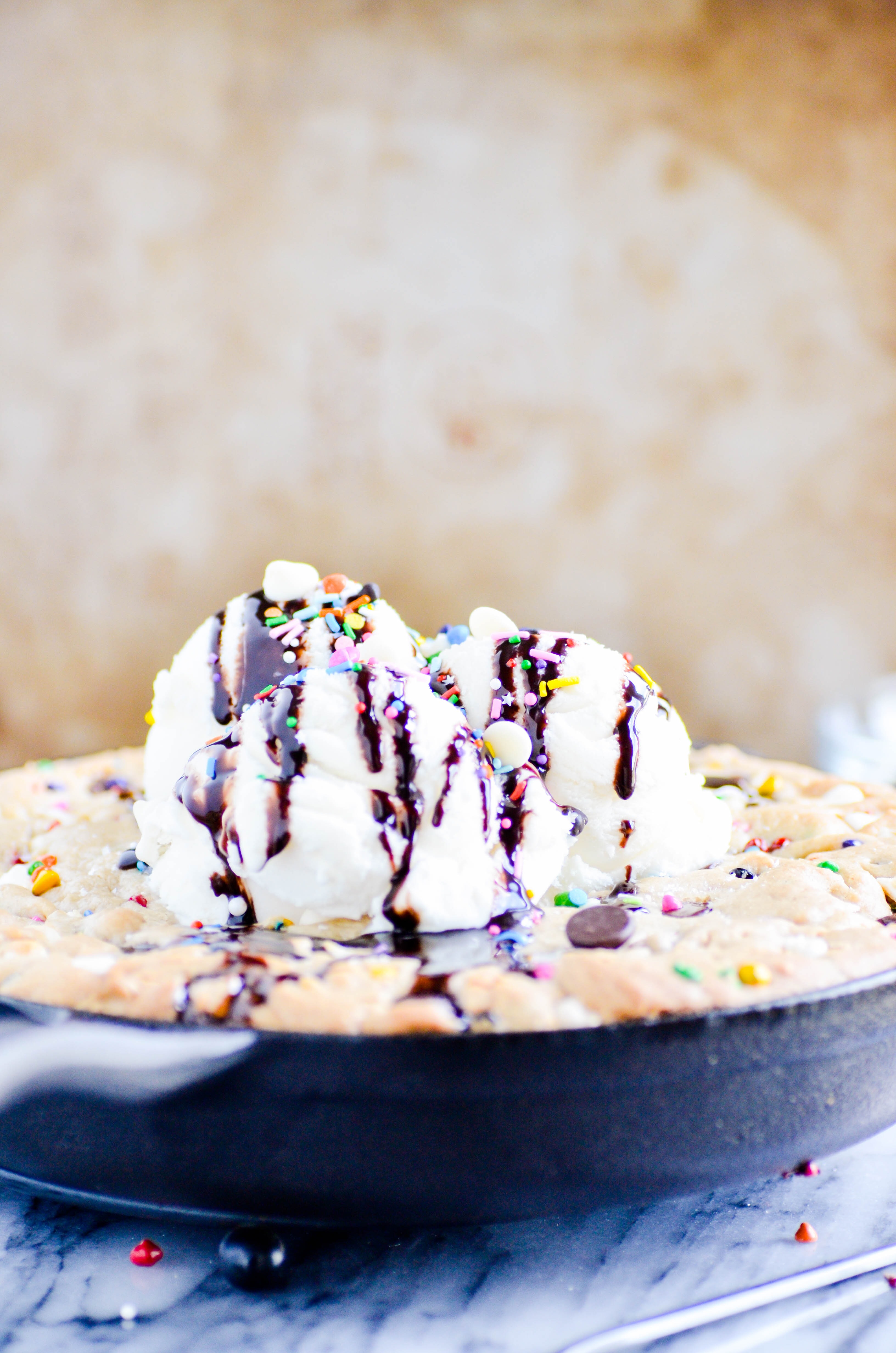 The most perfect dessert of all time is a warm, gooey, gigantic chocolate chip cookie filled with rainbow chips and topped with ice cream. How can it possibly get better than this?!