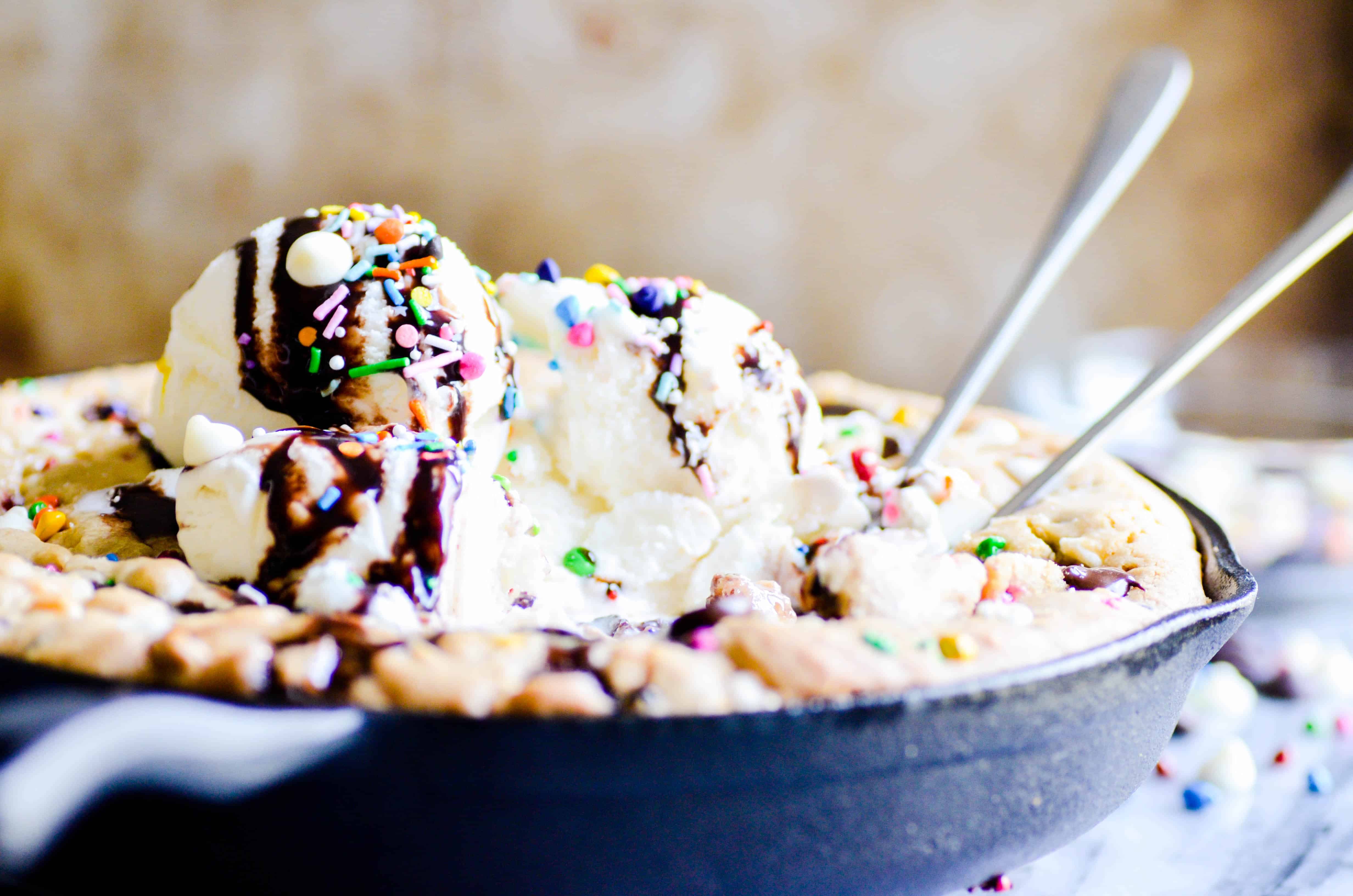 The most perfect dessert of all time is a warm, gooey, gigantic chocolate chip cookie filled with rainbow chips and topped with ice cream. How can it possibly get better than this?!