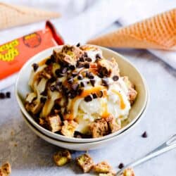 Check out this summer sundae topped with a peanut butter drizzle, homemade marshmallow sauce, chocolate chips, and Reese's Puffs Treats Bars.