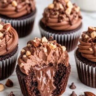 These All-the-Way Nutella Cupcakes have Nutella in the batter, filling, AND frosting. Total dream cupcake — you HAVE to make these! 🍫