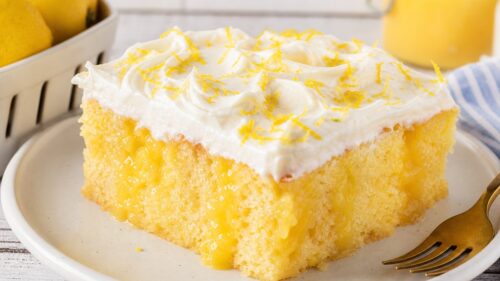 This Lemon Curd Poke Cake is moist, dreamy, and bursting with tart lemon flavor. So easy and absolutely delicious — you have to make this! 🍋