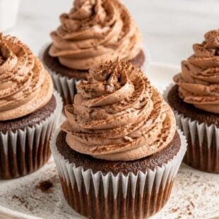 These Nesquik Buttercream Cupcakes are nostalgic, creamy, and SO dreamy! Chocolate milkshake flavor meets fluffy cupcake. You have to make these! 🍫