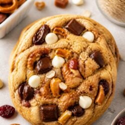 Make Panera's kitchen sink cookie recipe at home! Loaded with chocolate, caramel, pretzels & sea salt. Chewy, gooey & absolutely irresistible! 🍪