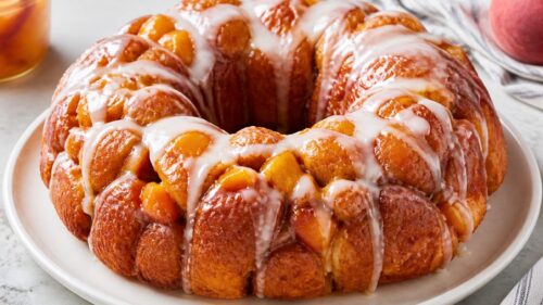 This peach monkey bread is gooey, dreamy pull-apart perfection loaded with juicy peaches — your new summer breakfast obsession! 🍑
