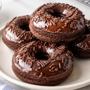 Devil's Food Cake Baked Donuts are rich, fudgy, and SO easy to make! Baked (not fried!) and dunked in a dreamy vanilla glaze. Ah-mazing!