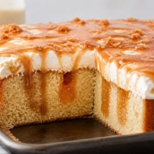 This caramel poke cake is gooey, dreamy, and SO easy to make! Yellow cake soaked in salted caramel and cheesecake pudding. You have to try it!