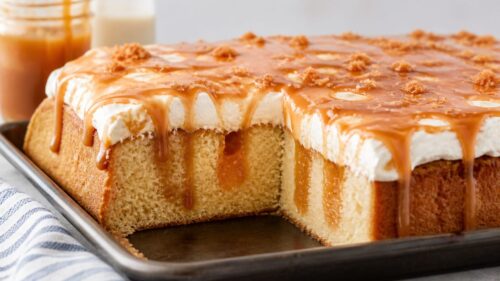 This caramel poke cake is gooey, dreamy, and SO easy to make! Yellow cake soaked in salted caramel and cheesecake pudding. You have to try it!