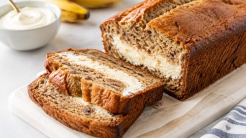 This banana bread cream cheese combo is moist, thick, and topped with dreamy frosting & pecans. The best banana bread you'll ever make!
