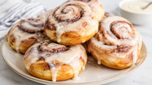 Easy Cinnabon donuts made from canned cinnamon rolls! Fried till golden, glazed till gooey — ready in 15 minutes flat. You have to make these!